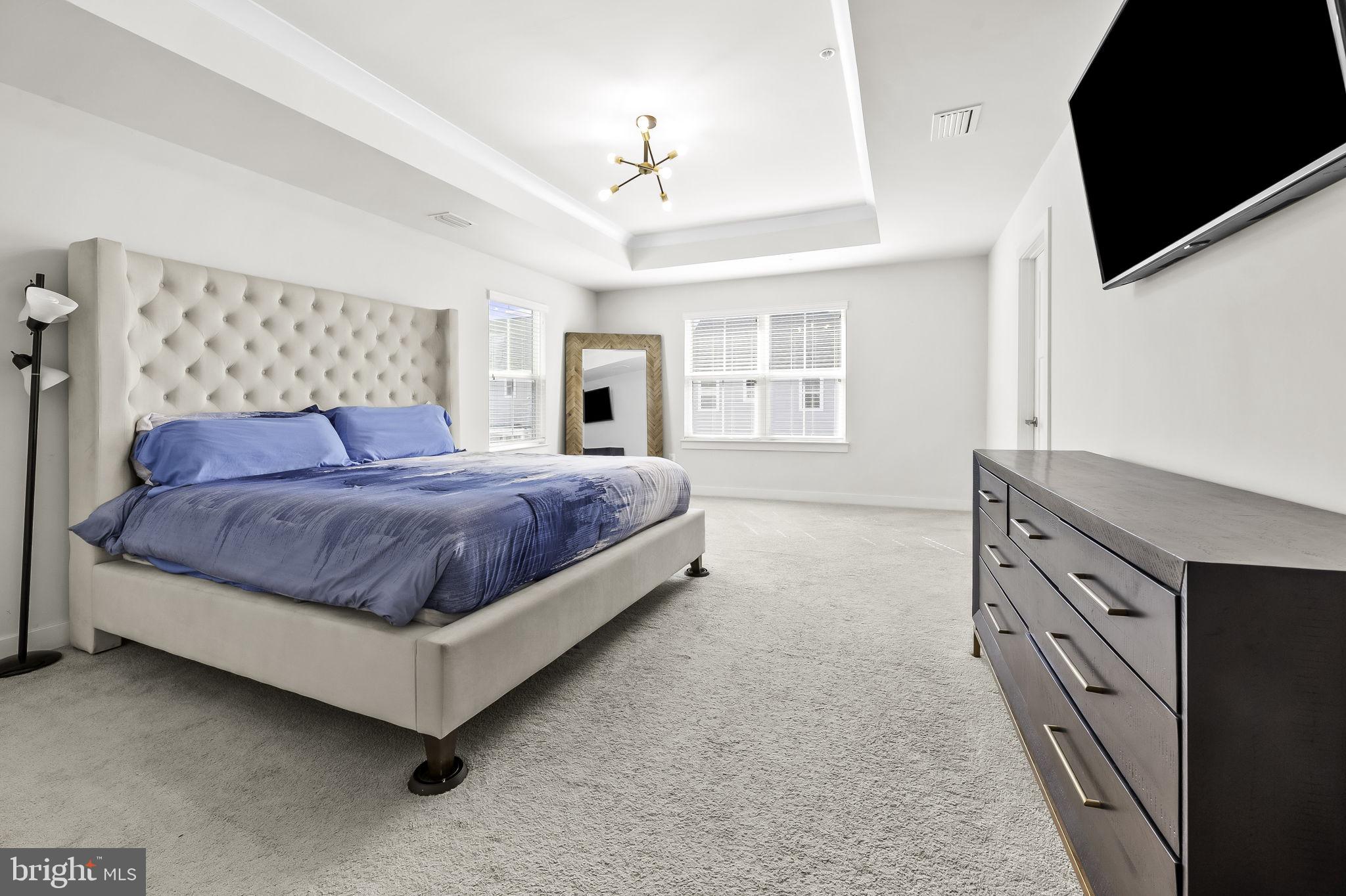 2157 Nottoway Drive Hanover, MD 21076 - Photo 32 of 50 a spacious bedroom with a bed and a flat screen tv