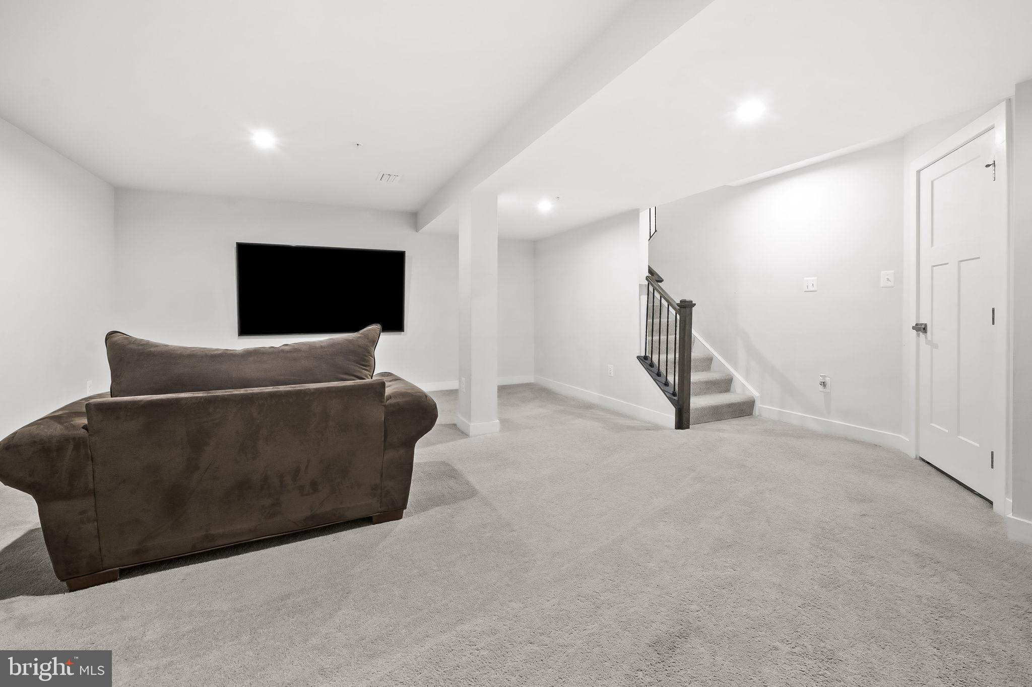 2157 Nottoway Drive Hanover, MD 21076 - Photo 40 of 50 a living room with furniture and a flat screen tv
