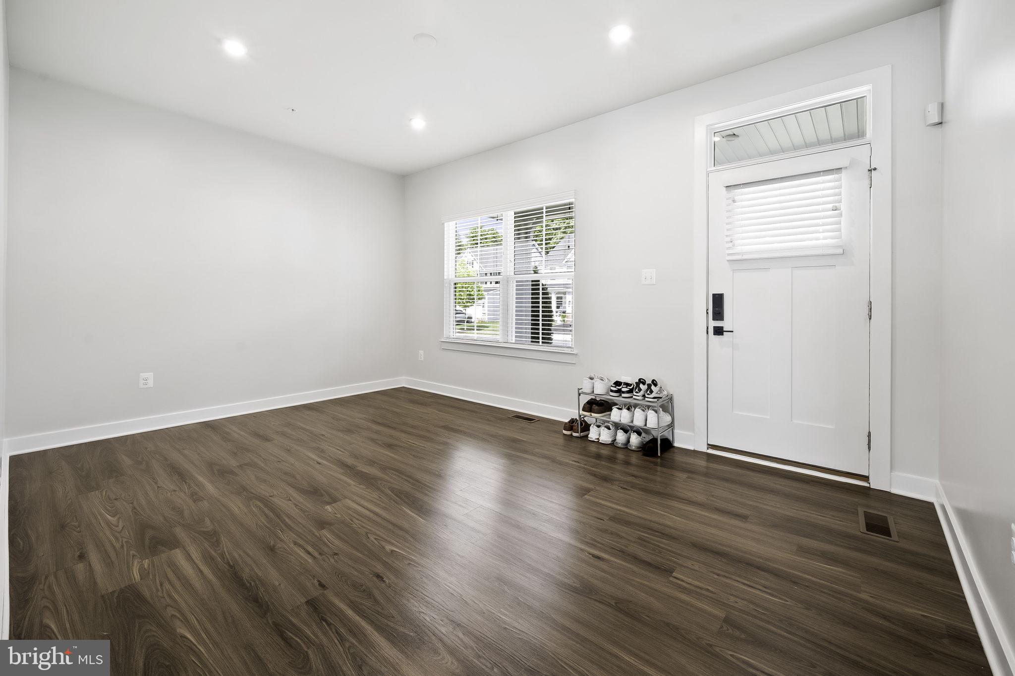 2157 Nottoway Drive Hanover, MD 21076 - Photo 9 of 50 an empty room with wooden floor and windows