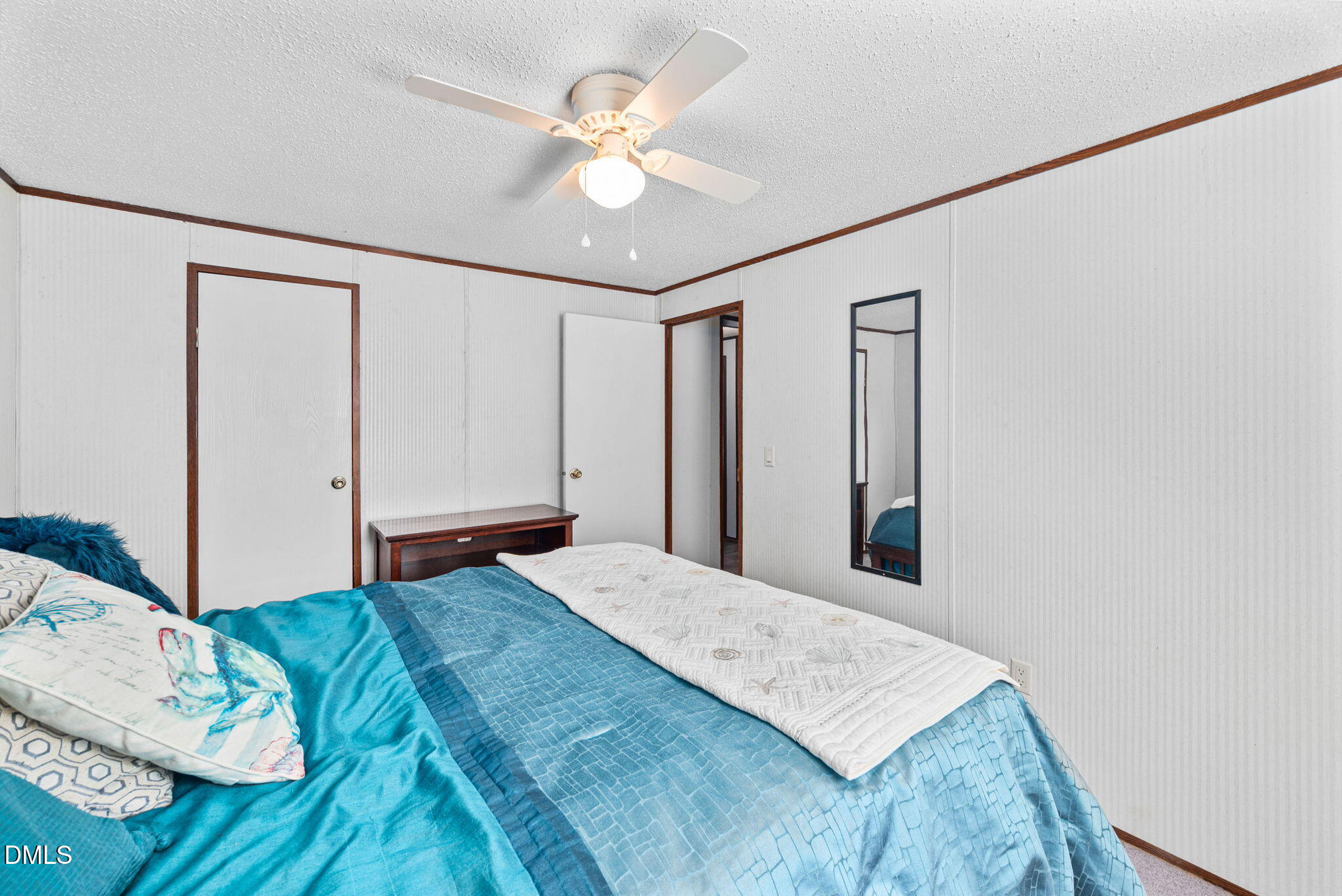 2005 Mooregate Court Clayton, NC 27520 - Photo 23 of 31 a bedroom with a large bed and a chandelier
