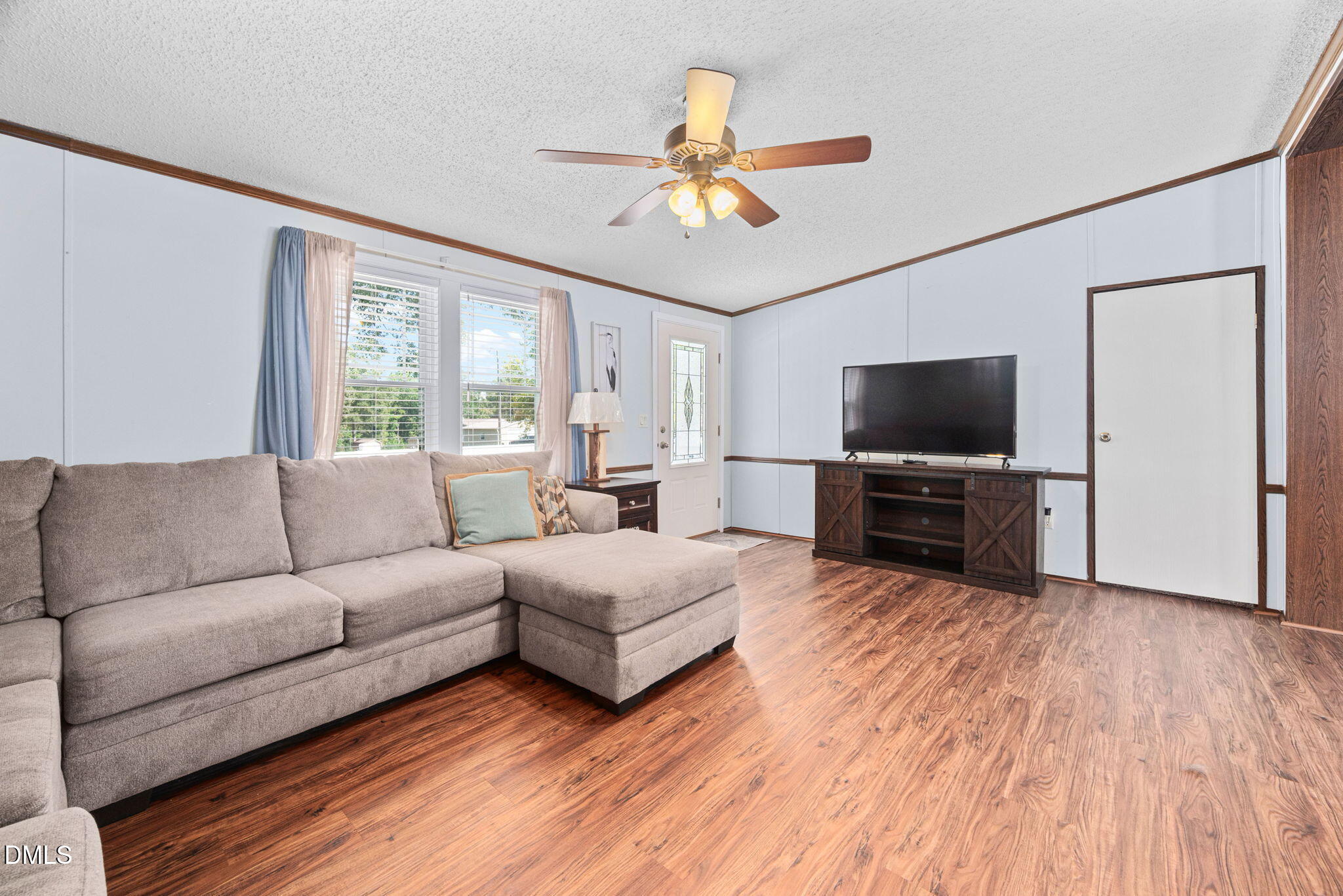 2005 Mooregate Court Clayton, NC 27520 - Photo 3 of 31 a living room with furniture and a flat screen tv