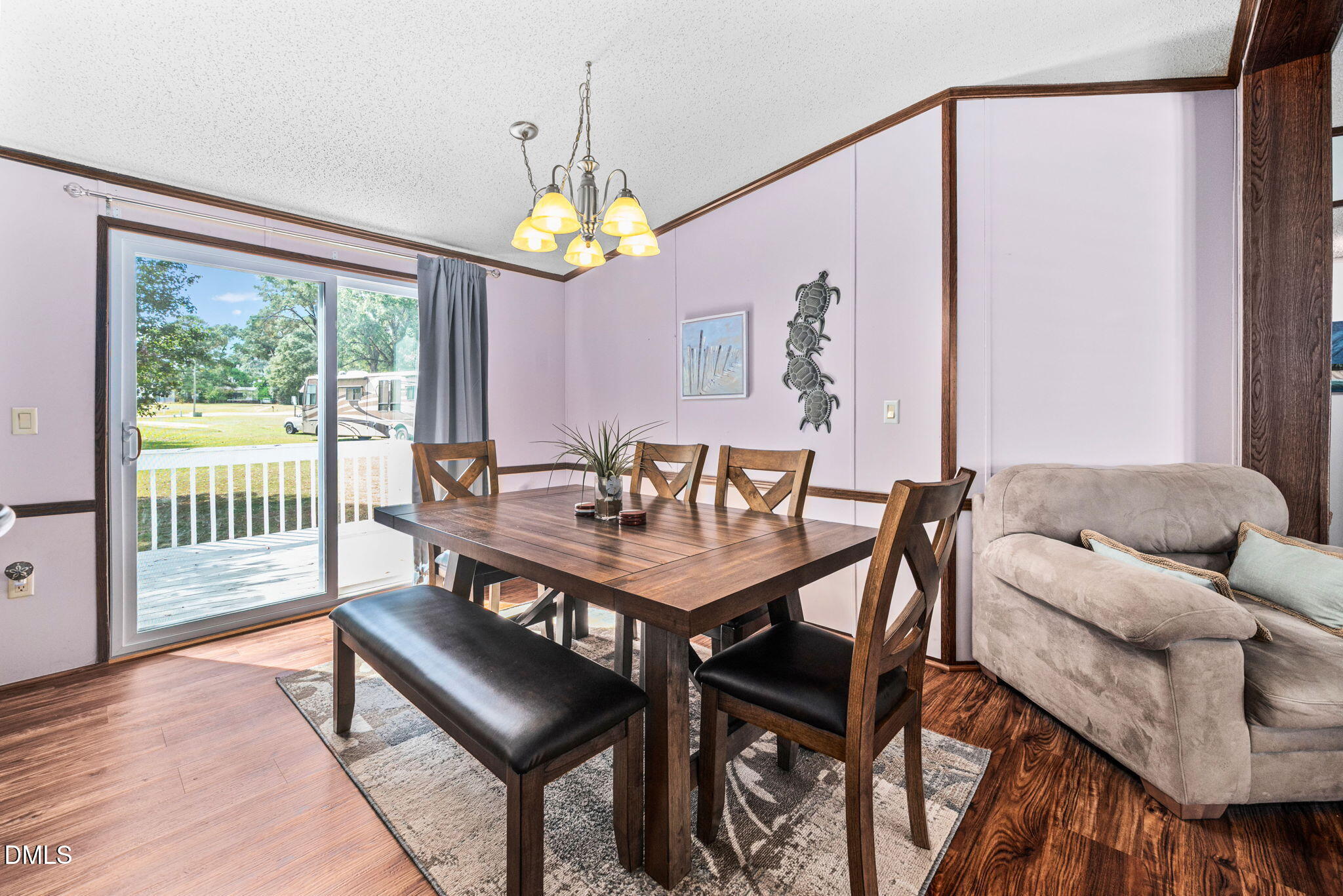 2005 Mooregate Court Clayton, NC 27520 - Photo 6 of 31 a view of a dining room with furniture a chandelier and wooden floor