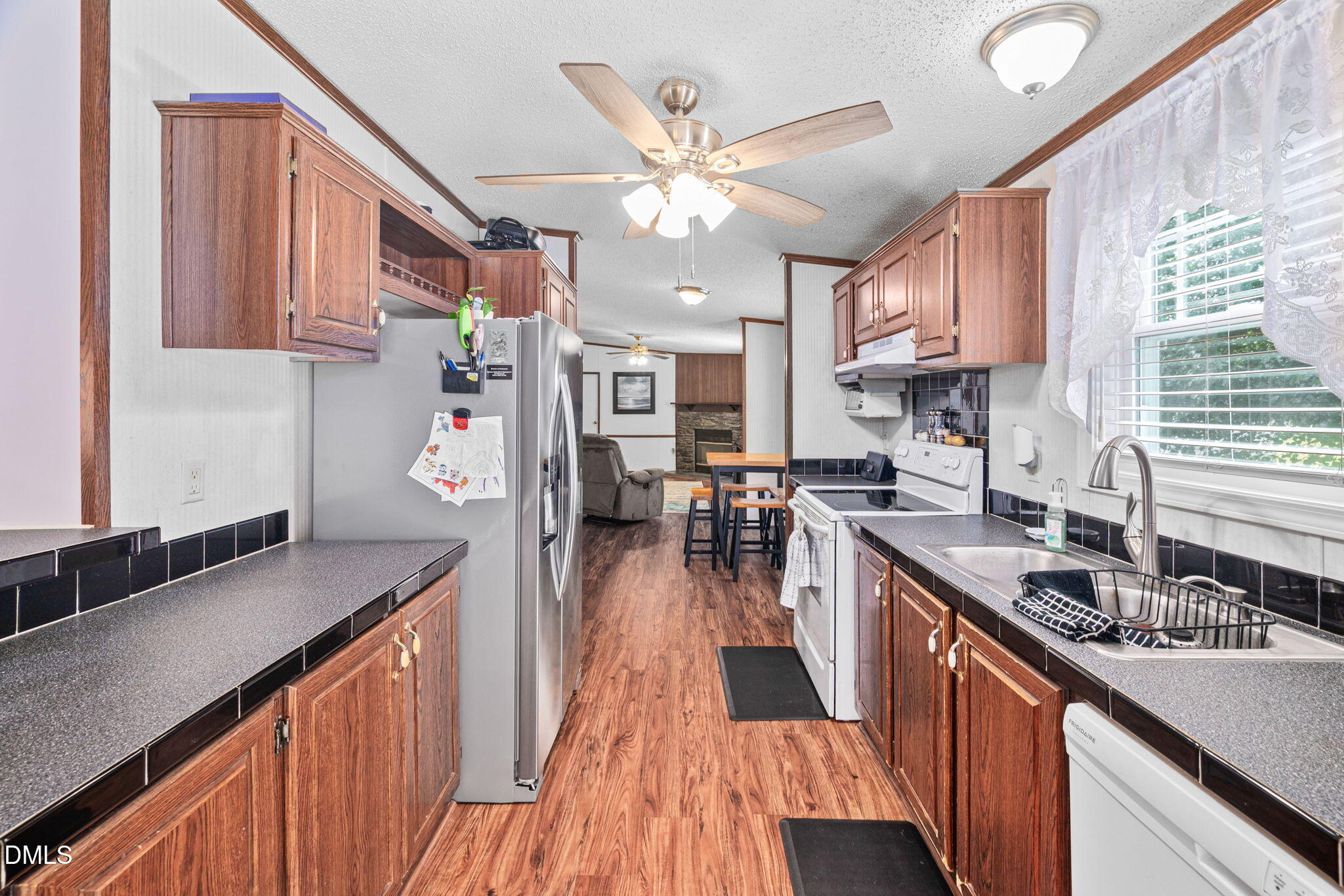 2005 Mooregate Court Clayton, NC 27520 - Photo 7 of 31 a kitchen with stainless steel appliances granite countertop a sink stove and wooden cabinets