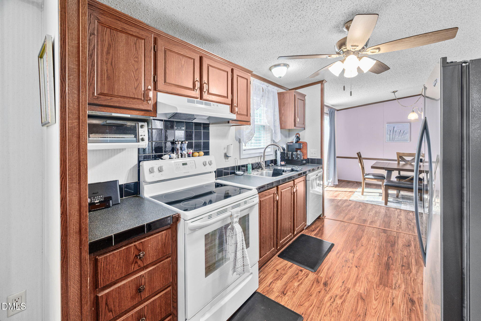 2005 Mooregate Court Clayton, NC 27520 - Photo 9 of 31 a kitchen with stainless steel appliances granite countertop a stove and cabinets