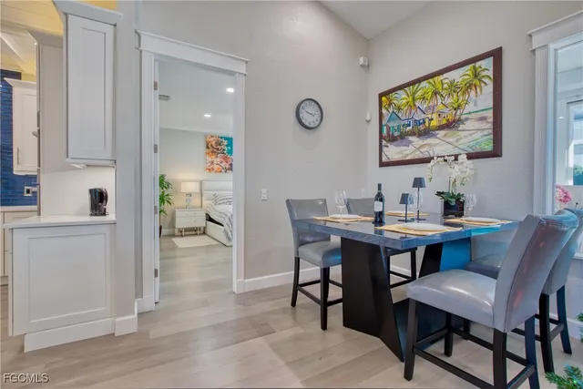 a view of a dining room with furniture a rug and wooden floor