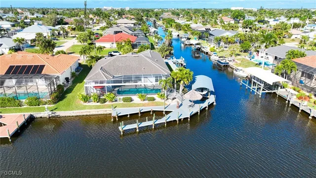a aerial view of a house with swimming pool and outdoor seating