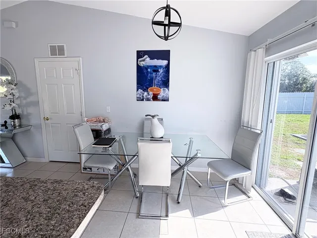 a dining room with wooden floor and a window