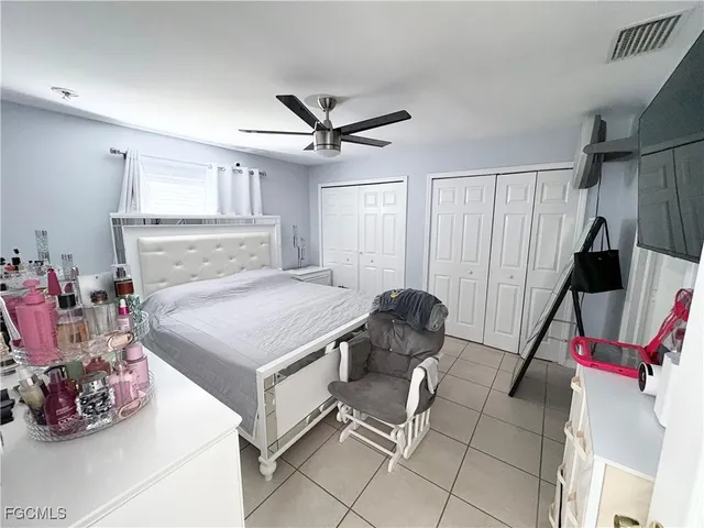 a bedroom with a bed and a ceiling fan