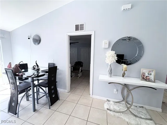 a living room with furniture and a mirror