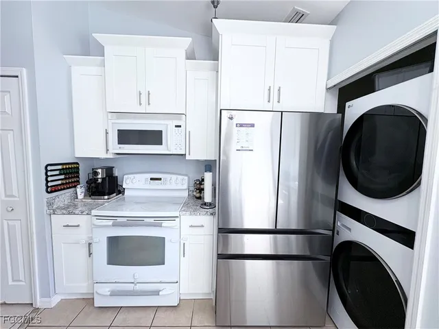 a kitchen with a refrigerator sink stove and cabinets