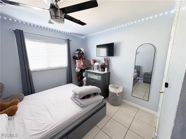 a bedroom with a bed and a television