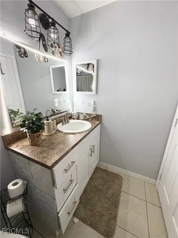 a spacious bathroom with a granite countertop sink a toilet and mirror