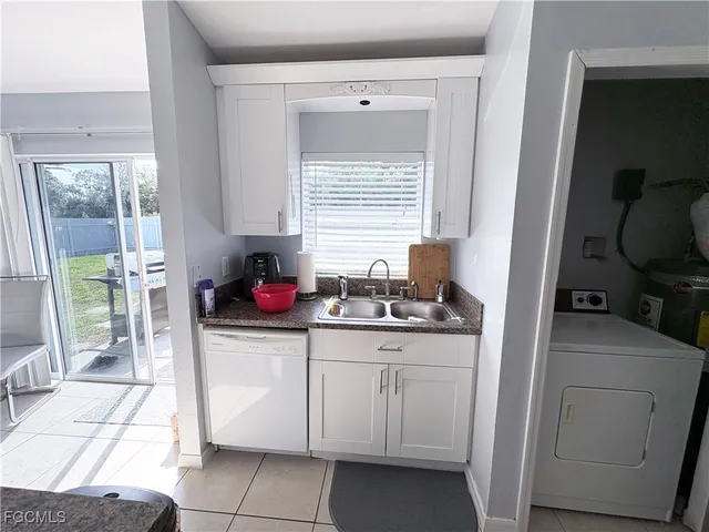a kitchen with sink a stove and cabinets