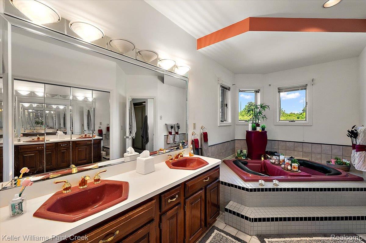 69069 Campground Road Romeo, MI 48065 - Photo 45 of 78 Dual vanity with wood cabinetry, rectangular white countertop, and integrated terracotta sinks