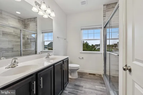 a bathroom with a shower and a sink