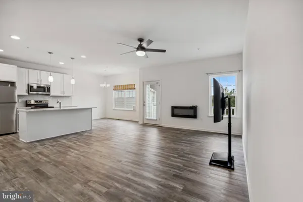 a view of kitchen with sink and wooden floor