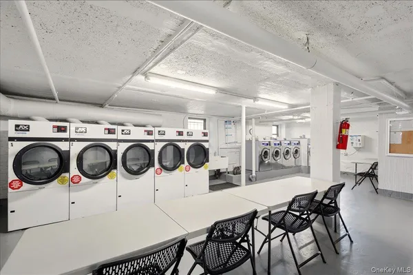 a kitchen with a dining table chairs and a stove top oven