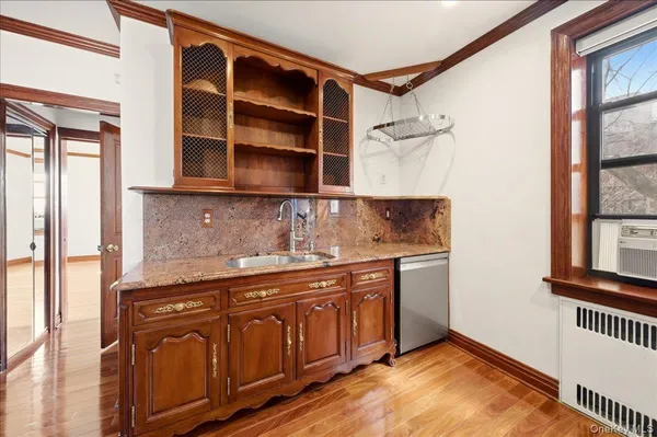 a kitchen with stainless steel appliances granite countertop a sink and a stove next to a window
