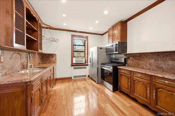 a kitchen with stainless steel appliances granite countertop a sink stove and refrigerator