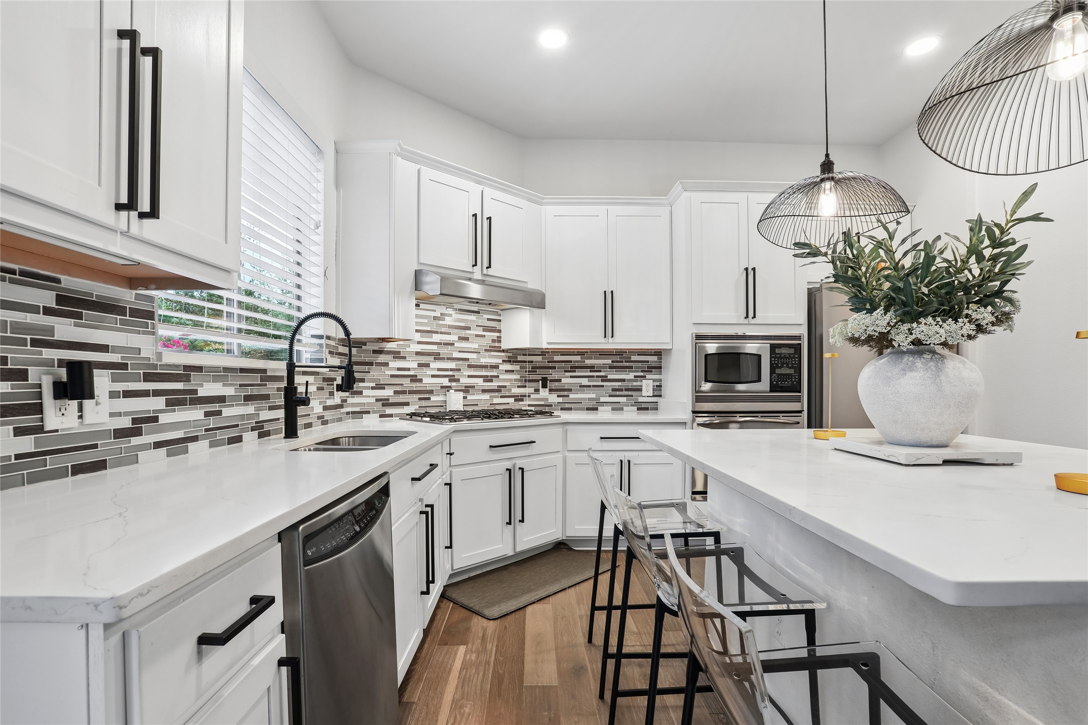 8110 Ranch Road 2222, Unit 10 Austin, TX 78730 - Photo 5 of 23 a kitchen with stainless steel appliances a white table chairs and a refrigerator