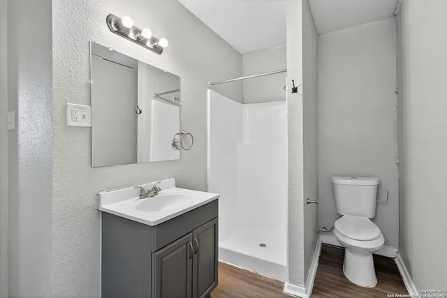 a bathroom with a toilet sink and mirror