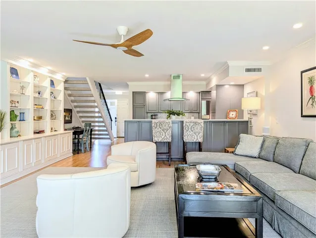 a living room with furniture and kitchen view
