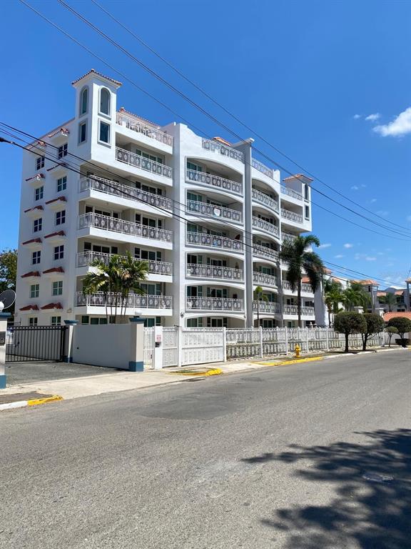 115 Rincon Prairie, Unit 1D Rincon, PR 00677 - Photo 1 of 1 a front view of a building with a road