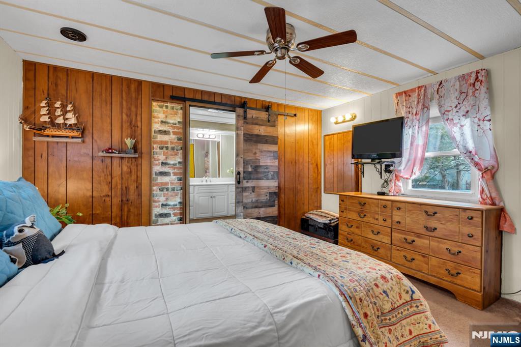 44 Nancy Lane Barnegat, NJ 08005 - Photo 16 of 23 a bedroom with a bed and a flat tv screen on dresser