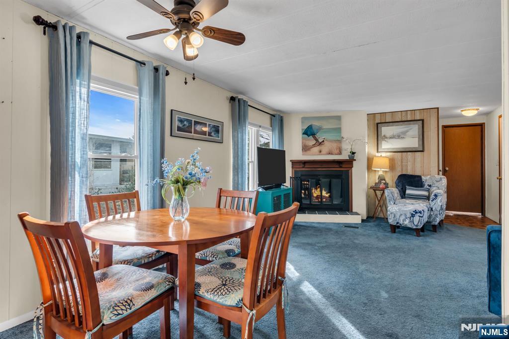 44 Nancy Lane Barnegat, NJ 08005 - Photo 8 of 23 a dining room with furniture a fireplace and a chandelier