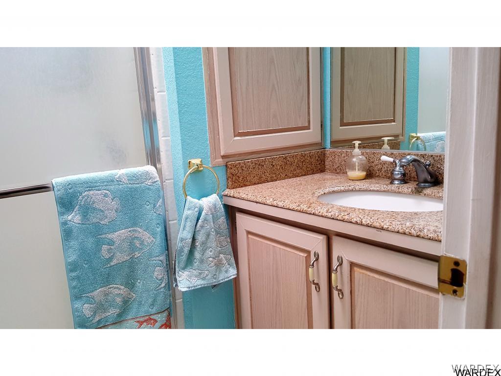 3256 South Tennessee Road Golden Valley, AZ 86413 - Photo 12 of 36 a bathroom with a sink and a mirror