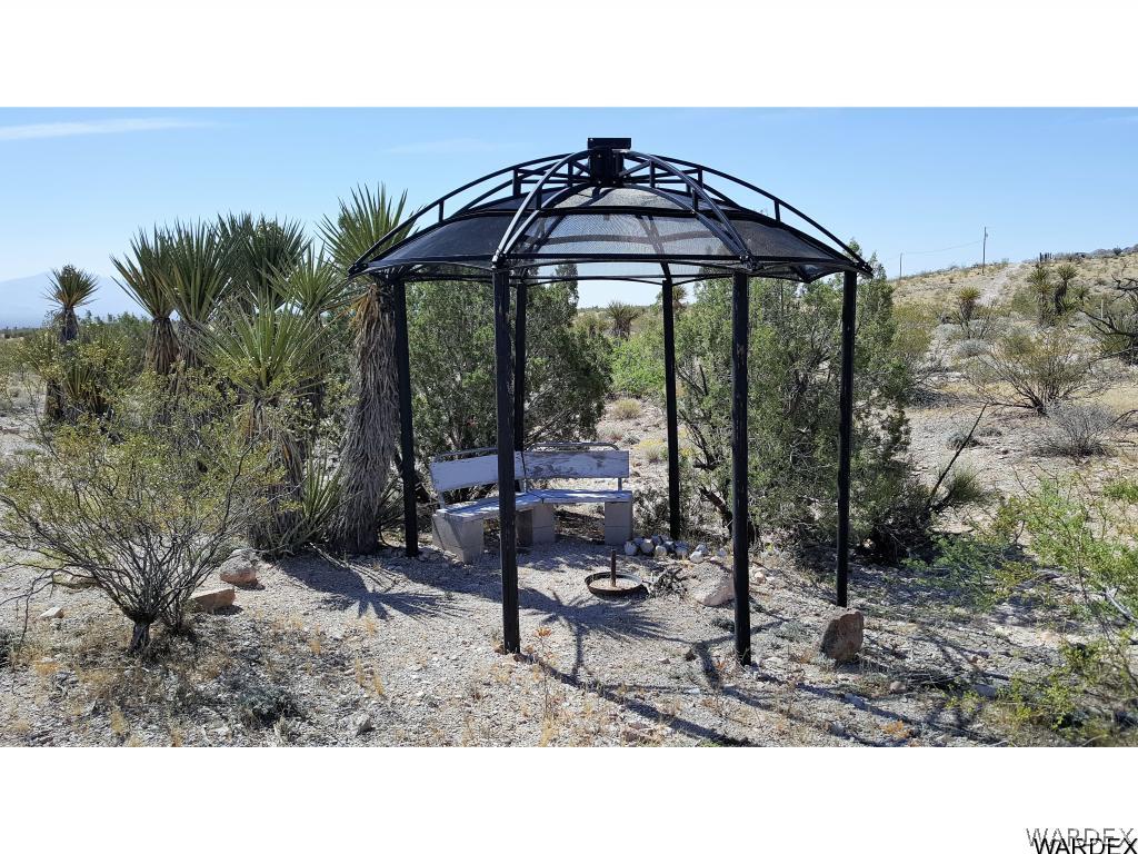 3256 South Tennessee Road Golden Valley, AZ 86413 - Photo 27 of 36 a backyard of a house with table and chairs