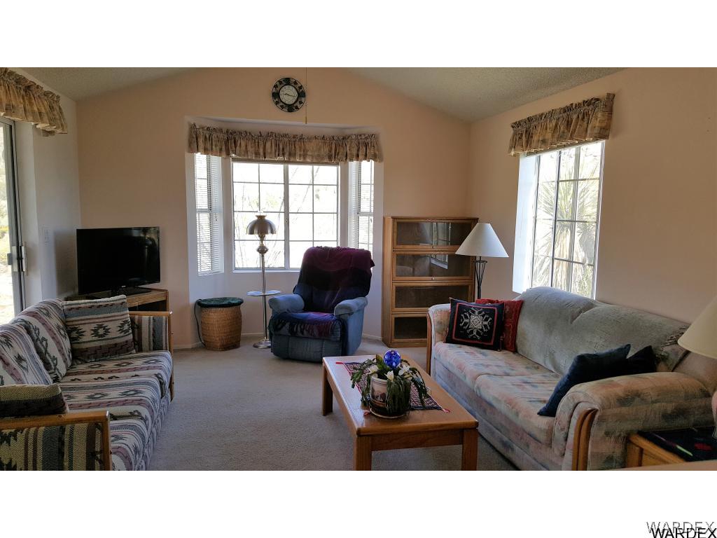 3256 South Tennessee Road Golden Valley, AZ 86413 - Photo 6 of 36 a living room with furniture and a flat screen tv