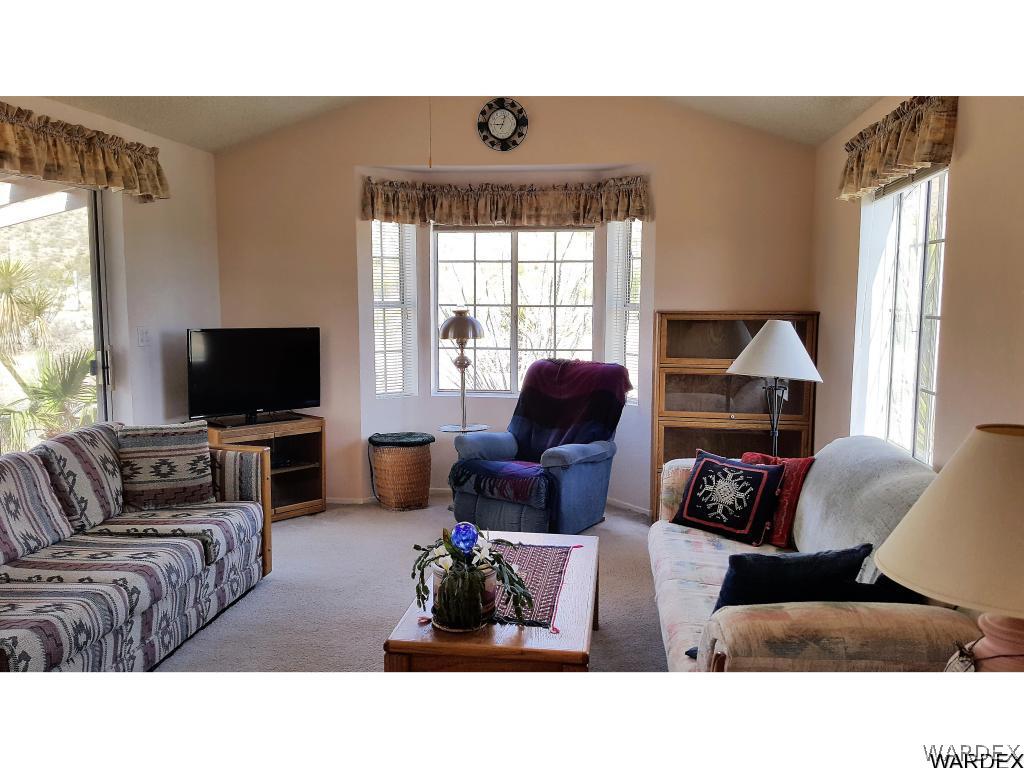 3256 South Tennessee Road Golden Valley, AZ 86413 - Photo 7 of 36 a living room with furniture and a flat screen tv