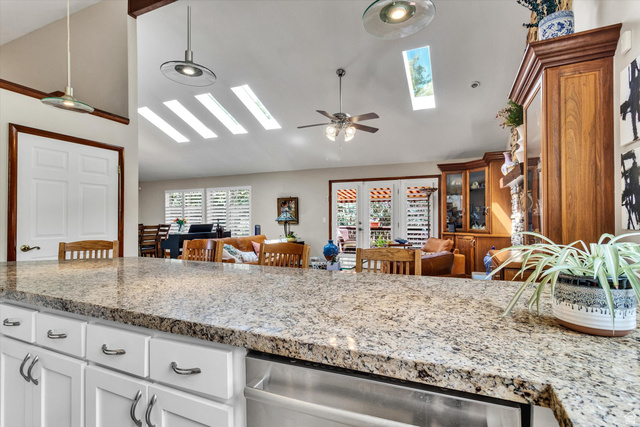 2863 Fallentine Road Sandy, UT 84093 - Photo 19 of 48 Spacious kitchen featuring a light-toned granite countertop and white cabinetry with brushed nickel hardware