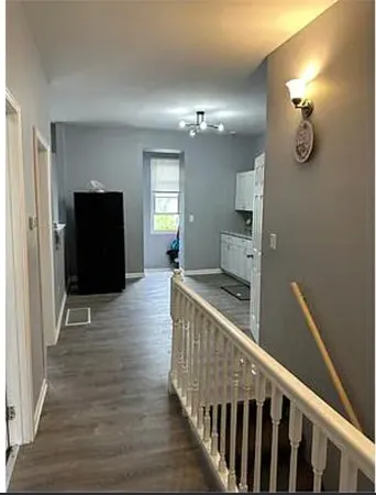 a view of a hallway view with wooden floor and staircase