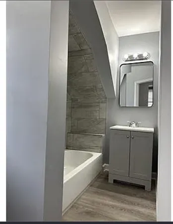 a bathroom with a bathtub and a sink