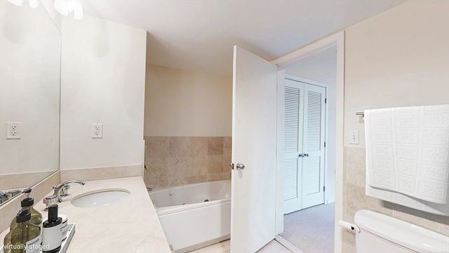 a bedroom with furniture and a large window