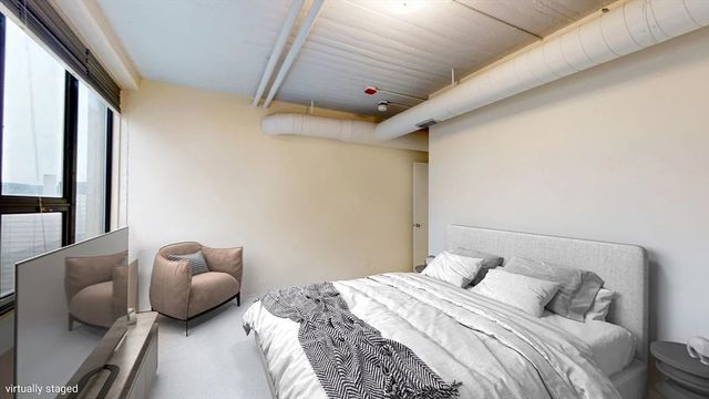 a living room with furniture and large windows