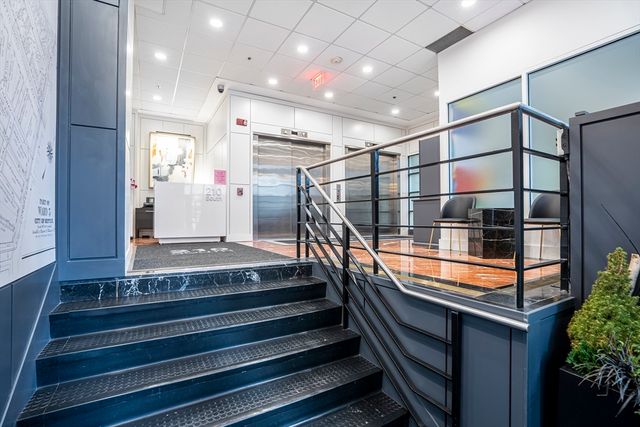 a view of a hallway with seating area