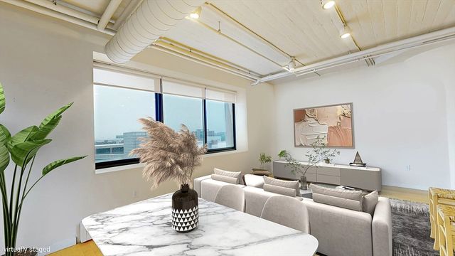 a dining room with furniture and a potted plant