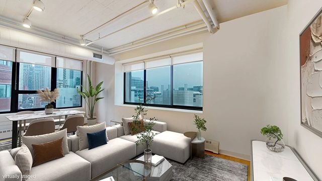 a living room with furniture and a large window