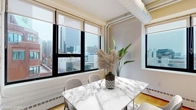 a vase of flowers sitting next to a window