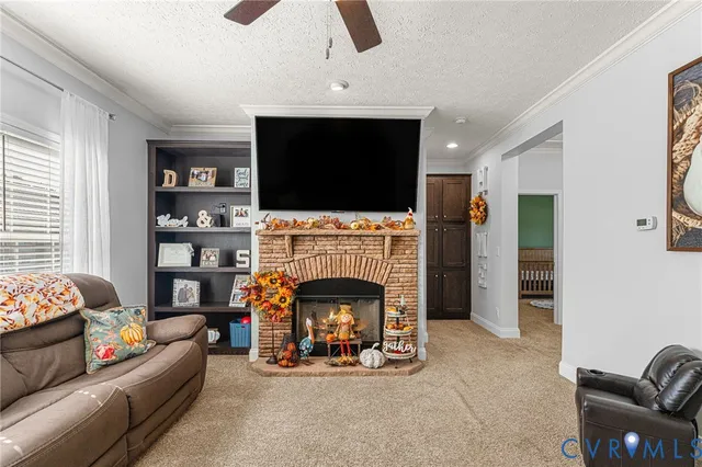 a living room with furniture a flat screen tv and a fireplace