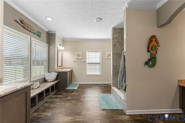 a bathroom with a tub a sink and a shower
