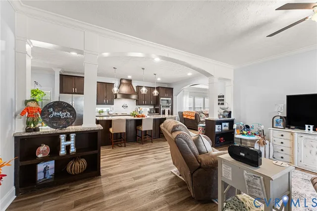 a living room with lots of furniture and wooden floor