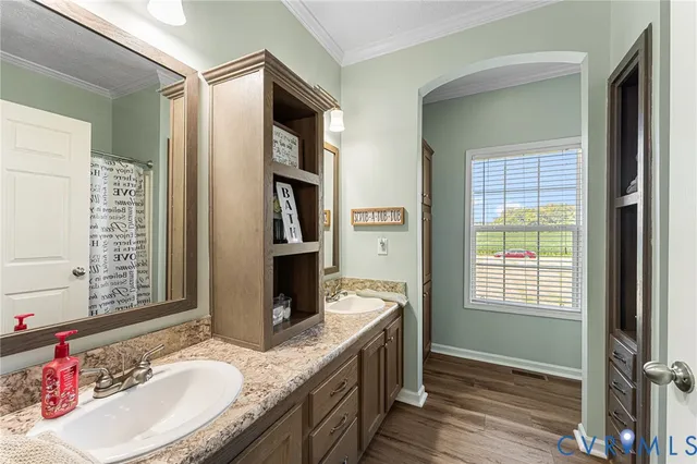 a bathroom with a granite countertop sink a mirror and a shower