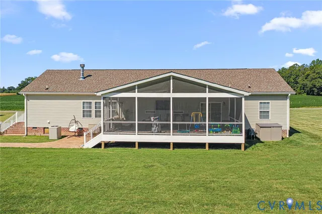 a view of a house with a yard and sitting area