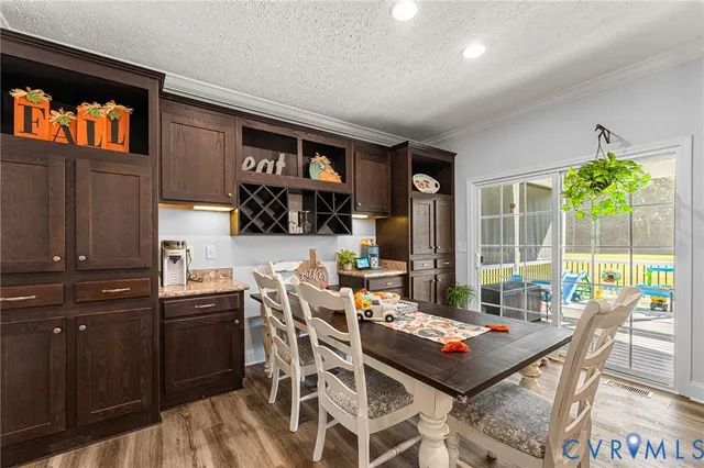 a living room with stainless steel appliances kitchen island granite countertop furniture and a fireplace