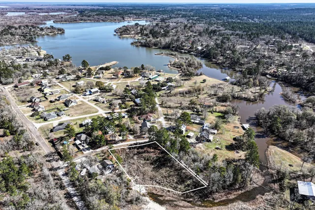 an aerial view of a house with a lake view