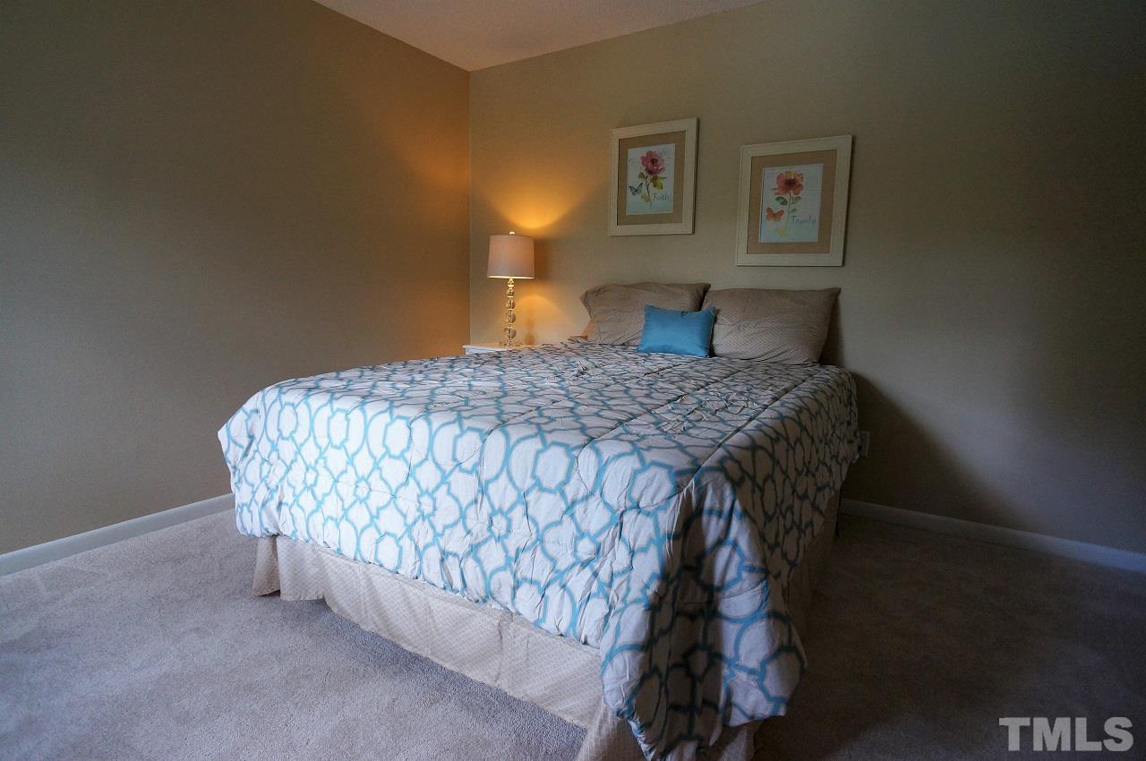 618 Pine Ridge Place, Unit 618 Raleigh, NC 27609 - Photo 11 of 20 a bedroom with a bed and painting on the wall